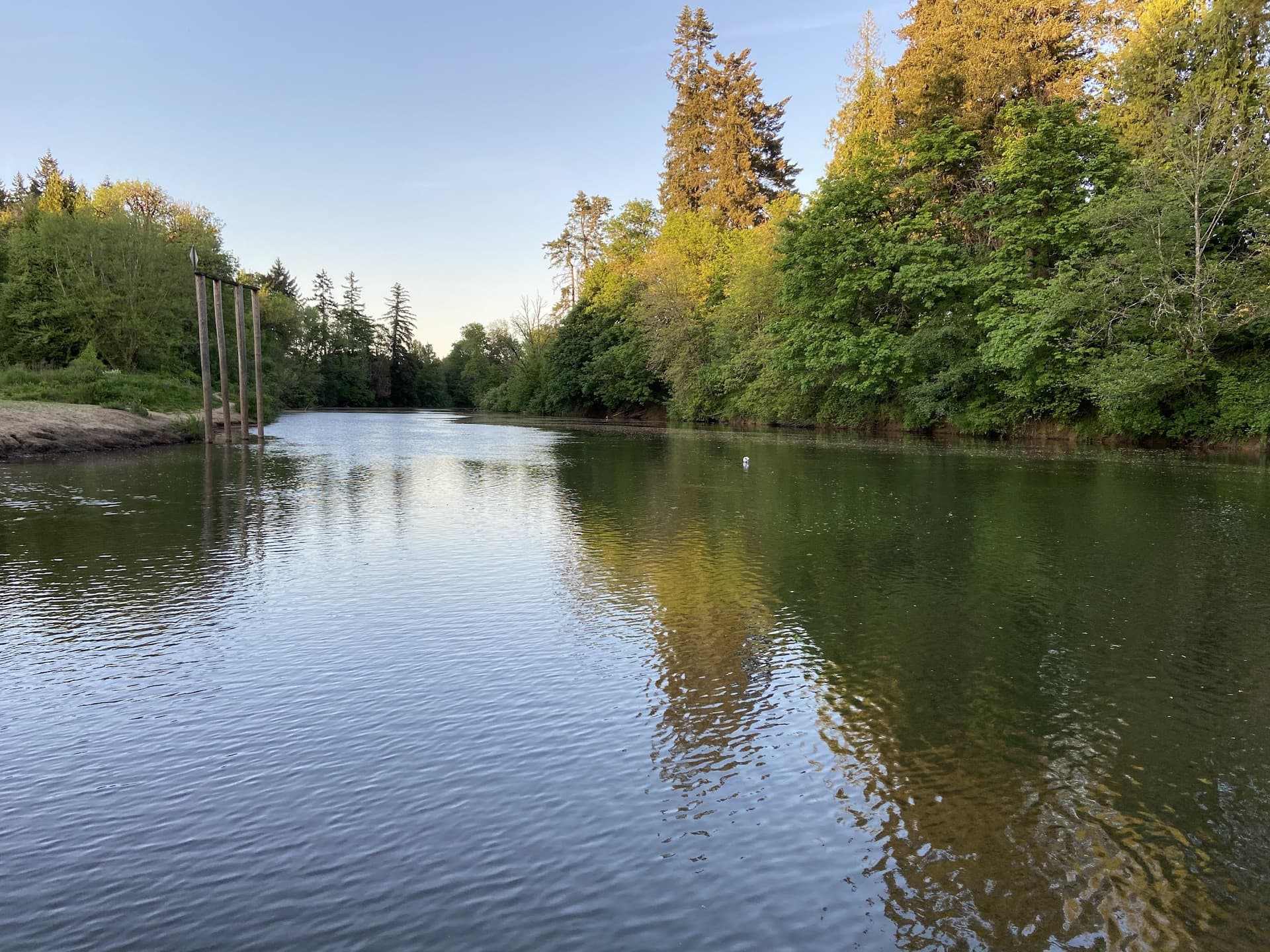 A quiet wooden dock extending onto a calm mountain lake at sunset