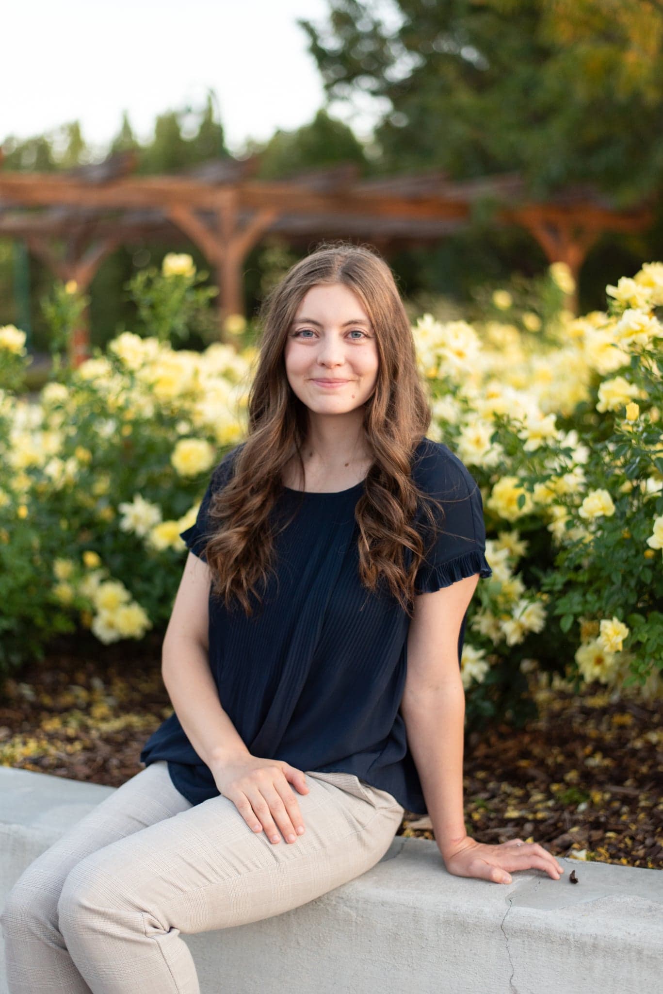 Madison seated outdoors among roses